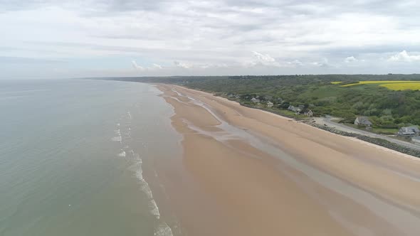 Establishing aerial drone view of isolated Omaha Beach near Colleville sur Mer, Normandy, France alt