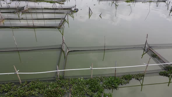 Aerial view of traditional floating fish pond on swamp in Indonesia alt