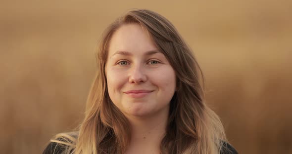 Lovely Natural Woman Smiling at Camera.