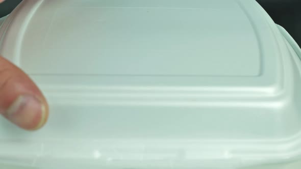 Male Hand Opens a Kebab on a Plate alt