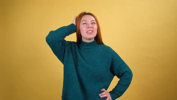 Young Red Hair Woman in Green Sweater Posing Isolated on Yellow Color Background Studio alt