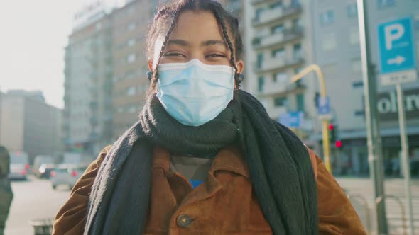 Portrait of young woman in face mask on street, Italy