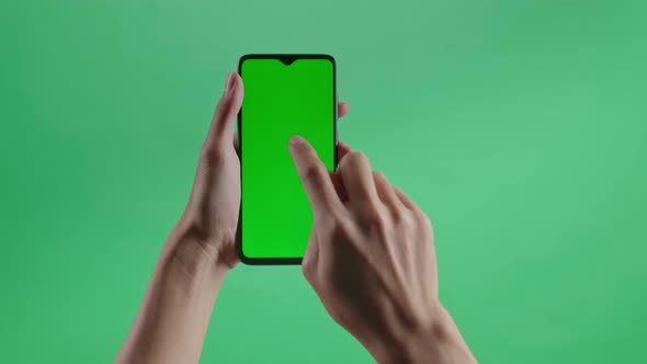 Hand Tap Touch Green Screen Smartphone On The Green Screen Background alt
