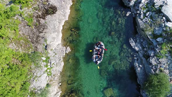 Aerial shot of a group of people enjoying in a rafting tour