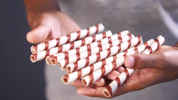 Holding Wafer Roll Chocolate Close Up alt