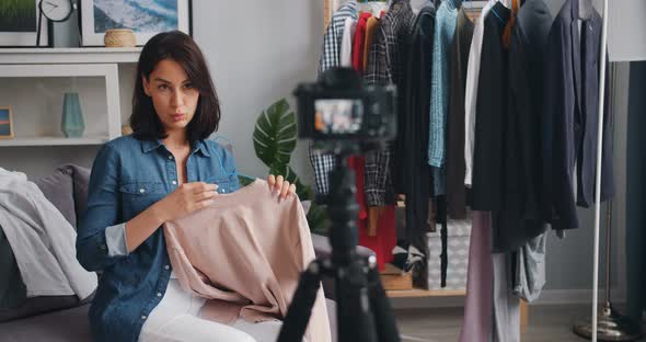 Slow Motion of Fashion Blogger Recording Video About Clothes at Home Talking alt