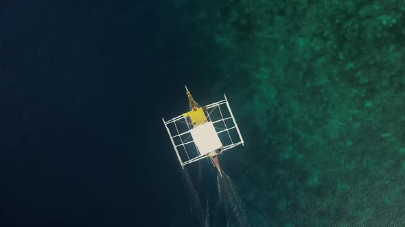 Aerial view of single filipino fishing boat near Lapu-Lapu city, Philippines. alt