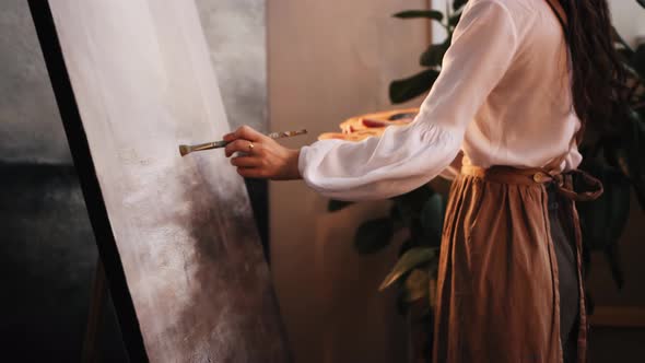 Art Studio  Young Woman Artist Painting a Replica of Another Painting Using a Small Brush alt