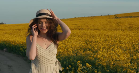 The Girl Is Answering the Phone in Surprise and Talking Happily alt