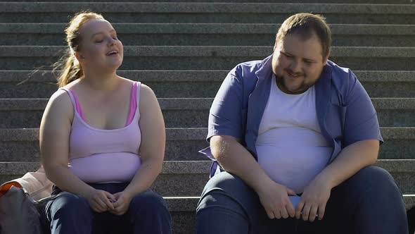 Cute Fat Couple Talking and Laughing, Sitting on Stairs, Relationship ...