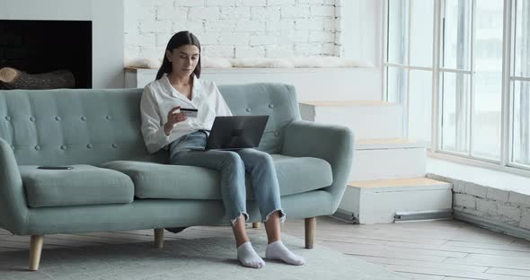 Caucasian Young Woman Using Credit Card and Laptop for Online Shopping alt