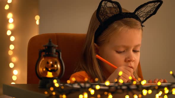 Girl Sits in Dark and Makes Decoration for Holiday Halloween