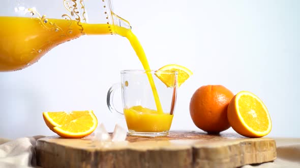 Pouring orange juice into glass