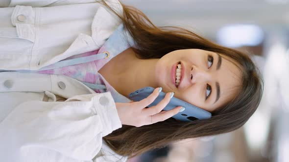 Vertical Screen Cheerful Woman Talking on Phone and Window Shopping alt