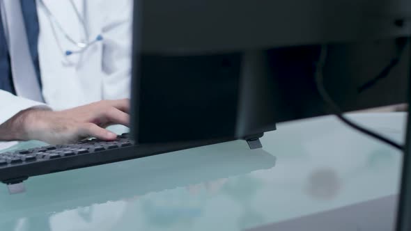 Doctor Hands Typing on Computer Keyboard alt