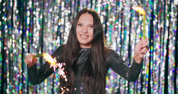 Cheerful Woman Holding Sparklers at the Party Teenage Girl Enjoying New Years Eve with Fireworks alt