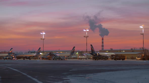 Area of Sheremetyevo Airport with planes and vehicles at the dawn in winter alt