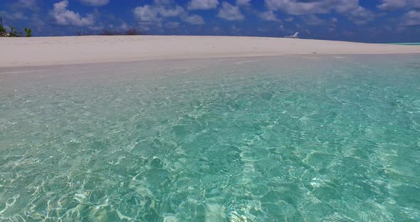 Daytime above travel shot of a sunshine white sandy paradise beach and blue ocean background in vibr alt