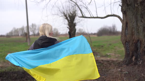 Woman Flag of Ukraine Near Burnt Tree