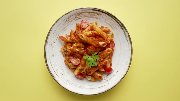 Penne Pasta with Tomato in Red Sauce on a White Plate