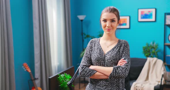 Portrait of the Successful Young Teenage Girl Crossing Her Arms and Smiling alt