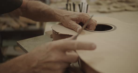 Carpenter placing top guitar part on the mold