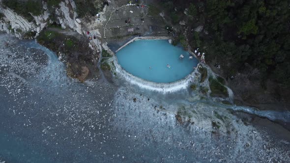 Drone view of people swimming and bathing in hot springs