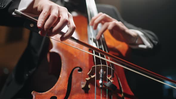 Cellist is Playing Cello on Scene of Music Hall Closeup View Rehearsal or Concert of Symphonic alt