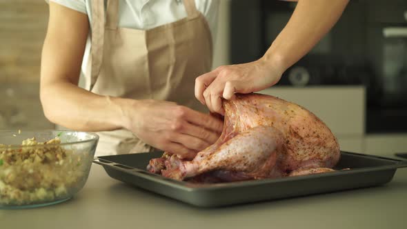 Filling Raw Turkey With Stuffing