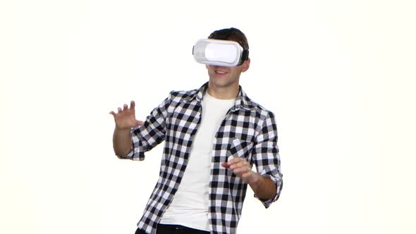 Man Playing Online Game Wearing Virtual Reality Glasses. White Background alt