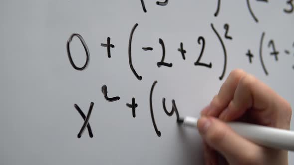 Hand Writing Mathematics Equation on Whiteboard Close Up