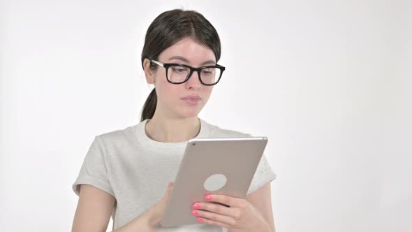 Serious Young Woman Working on a Tablet on White Background  alt