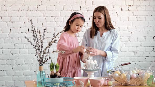 Cute Little Kid Daughter Helping Mom Adding Preparing Dough for Cake Together in Modern Kitchen