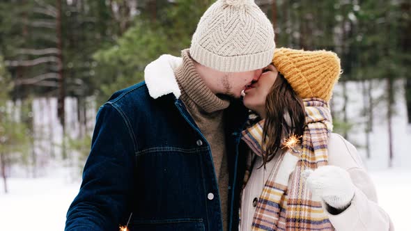 Happy Couple with Sparklers Kissing in Winter Park alt