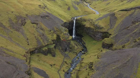thin waterfall in the mountains of iceland alt