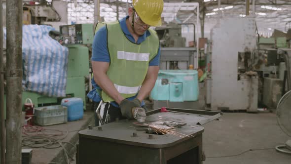 Young asian man welding iron at industrial factory, welder working job. alt
