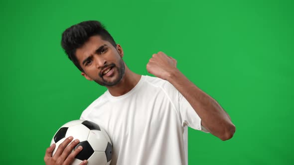 Inspired Middle Eastern Man Gesturing Yes Posing at Chromakey Background with Football Ball alt