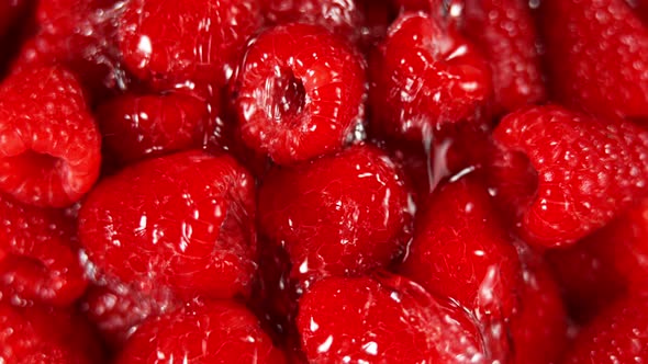 Super Slow Motion Shot of Splashing Water To Fresh Raspberries at 1000Fps. alt