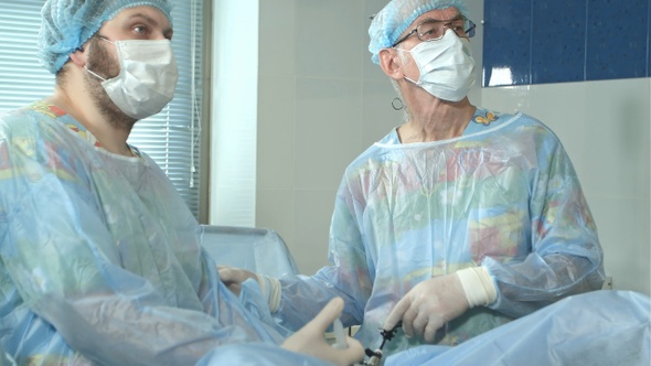 Two surgeons operating in hospital