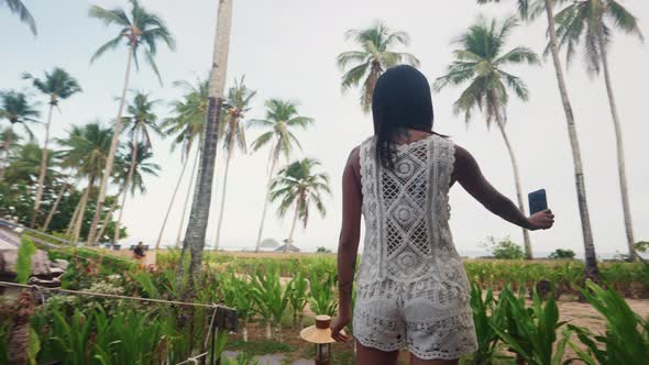 Pretty Woman Making Selfies on Terrace in Front of Tent House of Luxury Resort alt