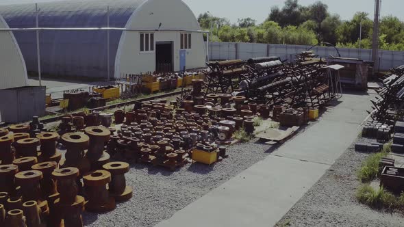 Aerial View Oil and Gas Wellhead Tree Equipment Production Plant. The Working Process in a Warehouse alt