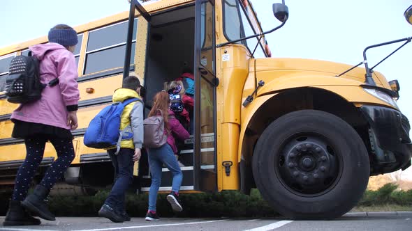 Diverse Elementary Age Kids Getting on School Bus alt