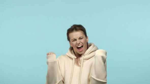 Slow Motion of Happy Blonde Girl Making Fist Pumps and Celebrating Victory Achieve Success and alt