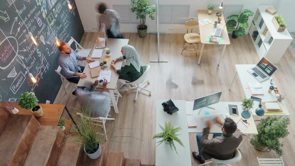 High Angle View Time Lapse of People Colleagues Working in Creative Office Together Moving alt