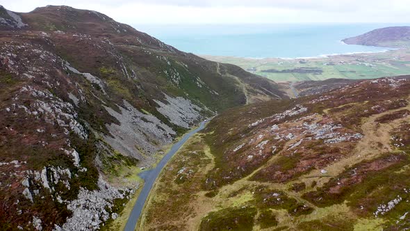 White Car Driving Through Gap Mamore Inishowen Peninsula County Donegal  Republic Ireland alt