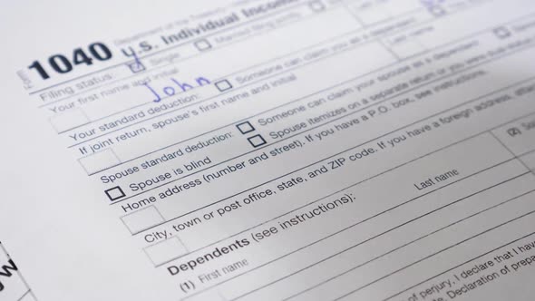 Male Hand Filling 1040 Tax Form