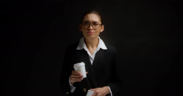 Business Woman is Waiting for Someone Looking at a Cell Phone alt