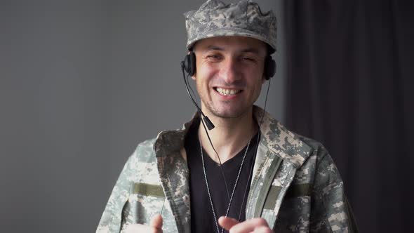 Military Man in Headphones Talking in Slow Motion Looking at Camera