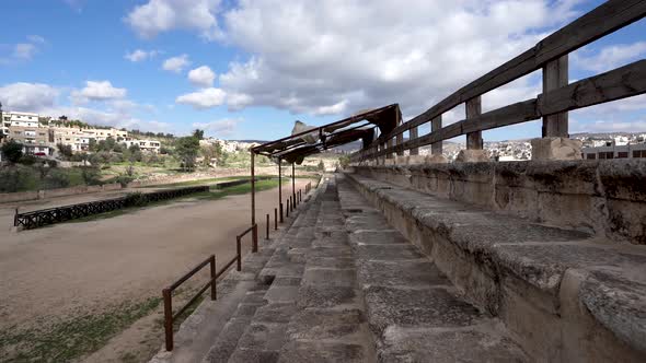 Hipodrome of Roman Ruins in the City of Jerash with Wind Blasting Textile Roof Over Viewers Section alt