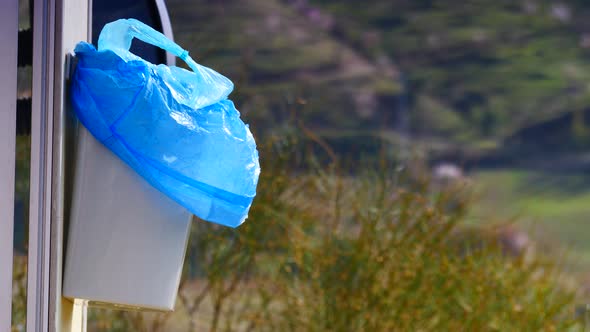 Trash Can with Plastic Bag on Caravan Door